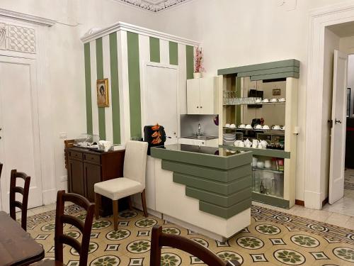 a kitchen with green and white stripes on the wall at La Bella Napoli B&B in Naples