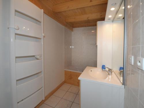 een witte badkamer met een wastafel en een douche bij Appartement Les Menuires, 4 pièces, 10 personnes - FR-1-452-83 in Les Menuires