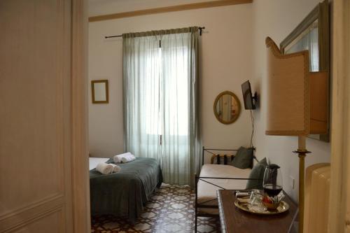 a living room with a bed and a window at Florence Heart B&B in Florence