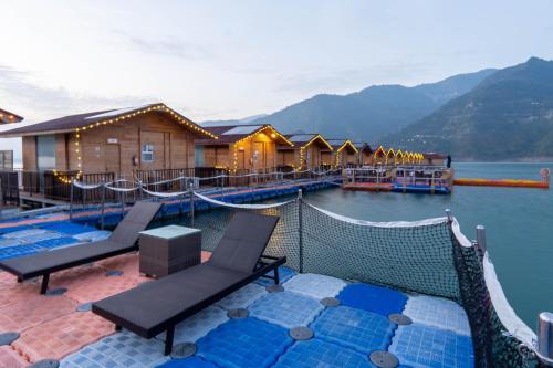 a resort with a view of a body of water at Le ROI Floating Huts & Eco Rooms Tehri in Tehri-Garhwāl