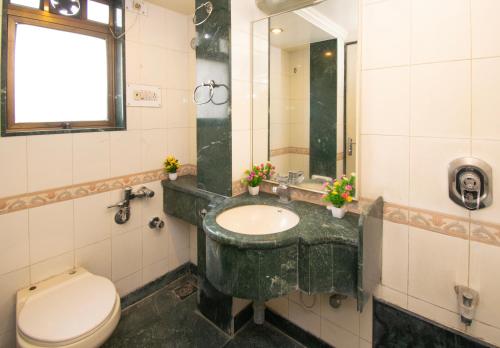 a bathroom with a sink and a toilet at Octave Bund Garden in Pune