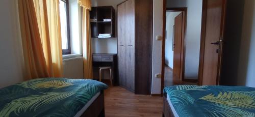 a small room with a bed and a window at Apartments Kapus Center in Bled