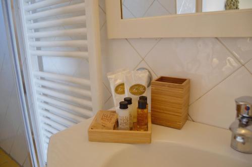 a bathroom counter with some products on a sink at Florence Heart B&B in Florence