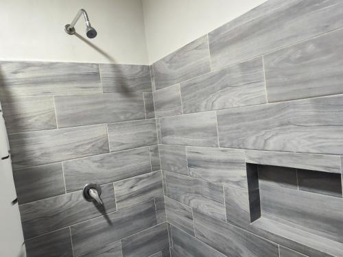a bathroom with a shower with gray tiles at Suite privada in San Martín de las Pirámides