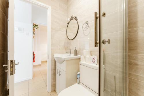 a bathroom with a sink and a shower at Wesferry beds to stay in London