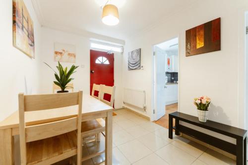 a dining room and living room with a table and chairs at Wesferry beds to stay in London