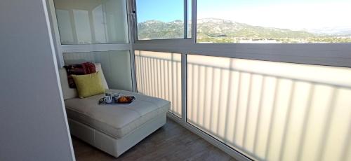 a room with a chair and a large window at Siesta in Hospitalet de l'Infant