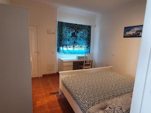 a bedroom with a bed and a desk and a window at Finca la fortaleza in San Miguel de Abona