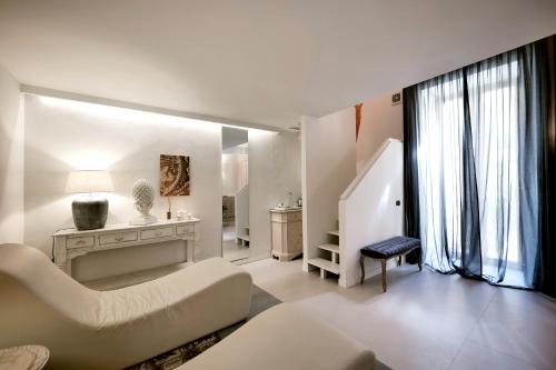 a white living room with a couch and a table at Dimora San Giuseppe in Lecce