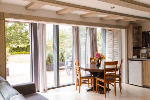 a kitchen and dining room with a table and chairs at Miera osta atpūtai Skultē Garāža in Skulte