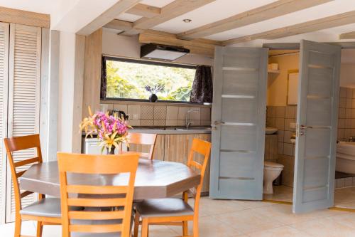 a kitchen with a table and chairs and a sink at Miera osta atpūtai Skultē Garāža in Skulte