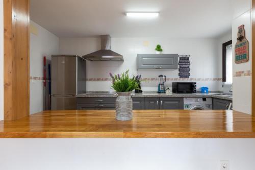a kitchen with a vase of flowers on a table at Tolox 2 in Tolox