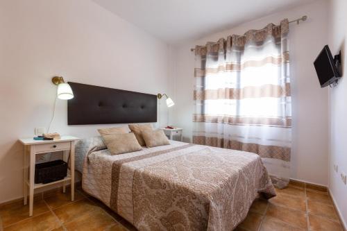 a small bedroom with a bed and a window at Tolox 2 in Tolox