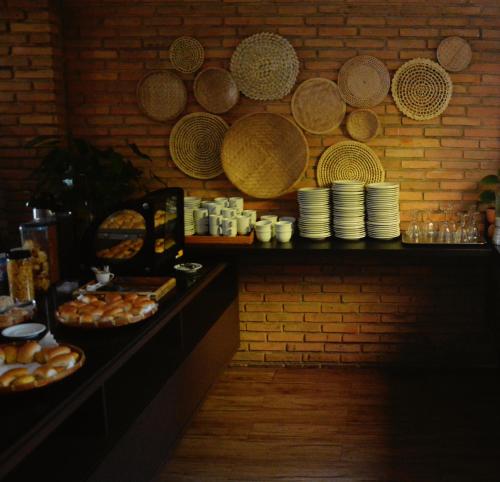 a table with plates and bowls of food on a wall at Cais da Praia Hotel in Maceió
