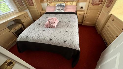 a bedroom with a bed with pink clothes on it at Freedom House in Clacton-on-Sea