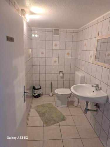 a bathroom with a toilet and a sink at pension sonne in Ulm