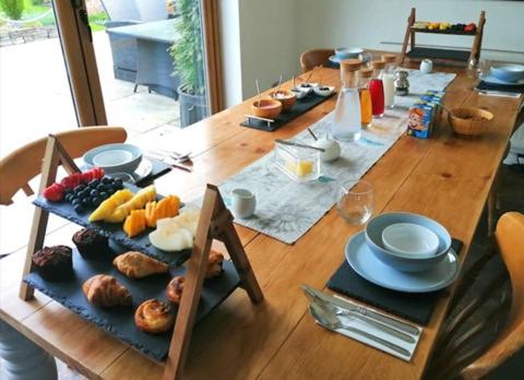 a long wooden table with plates and food on it at South View House in Waterlooville