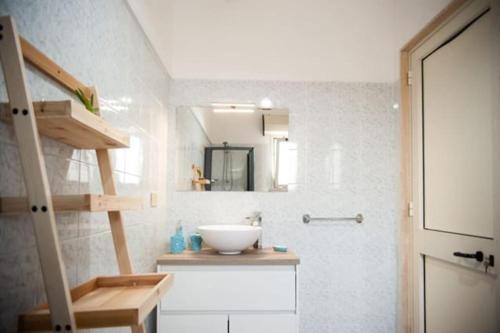 a bathroom with a sink and a mirror at Casa Tairsia in Torre Lapillo