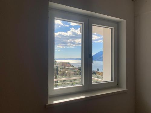 a window in a room with a view of the ocean at Appartamento Gardenia in Malcesine