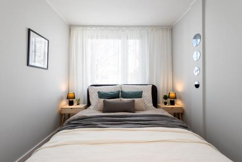 グリヴィツェにあるKairos Apartments - Friends - darmowy Parking, blisko centrumの大きなベッドと2つのナイトスタンドを備えた寝室