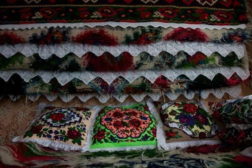 a group of colorful fabrics on a wall at Pensiunea Valea Branzei in Năneşti