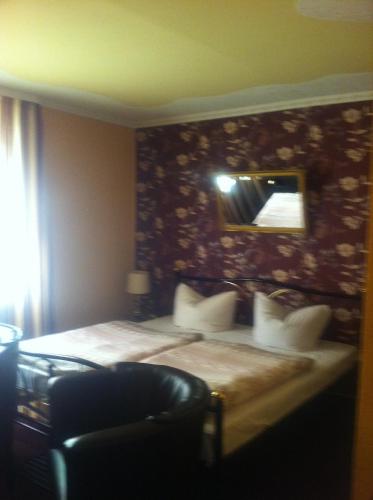 a hotel room with a bed and a mirror at Natur& Waldhotel Johannesruh in Wesenberg