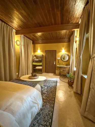 a bedroom with a bed and a table in a room at The Melo pomelo courtyard. ( Right in between Thamel and basantapur durbar square) in Kathmandu