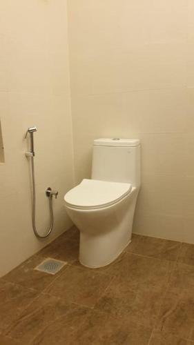 a bathroom with a white toilet in a room at The Melo pomelo courtyard. ( Right in between Thamel and basantapur durbar square) in Kathmandu