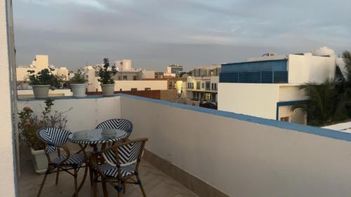 a table and chairs on a balcony with a view of a city at فلل الخالدية in Jeddah