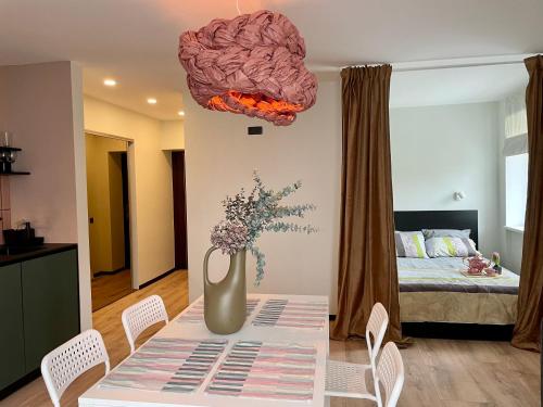 a room with a table with a vase with a brain on it at M a t c h a in Ventspils