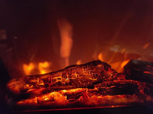 a close up of a fire in a fireplace at Le mazot d'H in Entremont