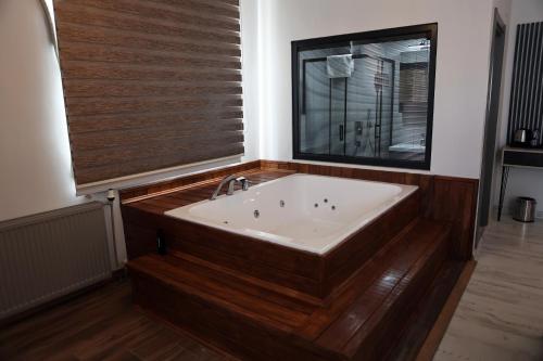 a bath tub in a room with a window at SAR-PER Hotel in Edirne