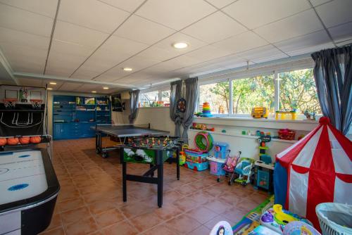 a room with a ping pong table and some toys at 10 Bedroom 5 Star Luxury Villa & Heated Pool for 5 to 28 Guests near Alicante in Mutxamel