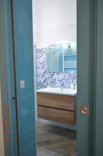 a bathroom with a sink and a mirror at La Casetta di Zoe Apartment in Molfetta