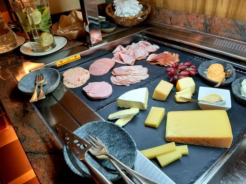a tray of cheese and meats on a counter at Hotel St. Georg in Zell am See