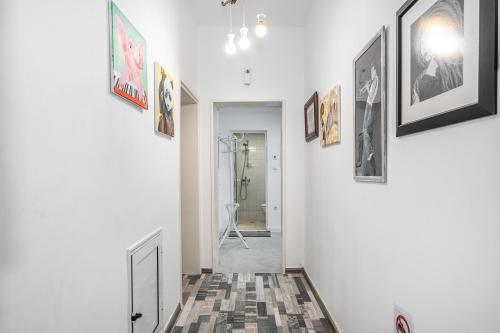 a hallway with framed pictures on the walls at Jazz & Wine - Luxury apARTment By The Sea & Parking & HBO & Netflix in Varna City