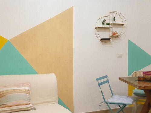 Habitación con sofá y mesa con silla. en La Casetta di Zoe Apartment, en Molfetta