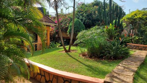 a garden with a house and some plants at Keelan ace villas in Kampala