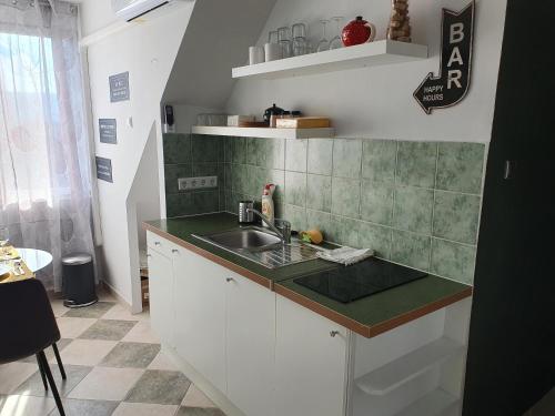 a kitchen with a sink and a counter top at Zöld Relax Apartments in Budakeszi