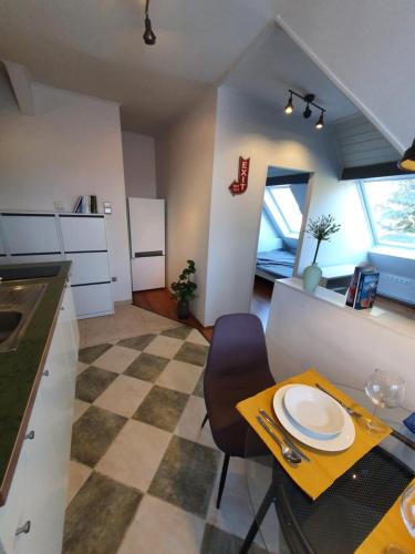 a kitchen with a table with a plate on it at Zöld Relax Apartments in Budakeszi