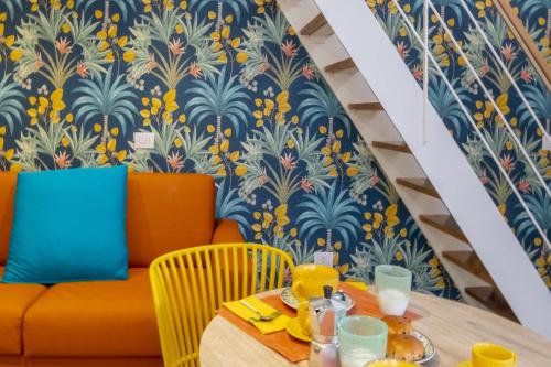 a dining room with a table and a couch at La Casetta a Sorrento in Sorrento