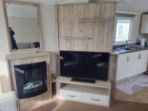 a living room with a flat screen tv and a flat screen at 8 Berth 3 Bed PG213 on the Golden Palm in Chapel Saint Leonards