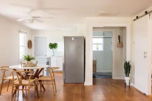 a kitchen and dining room with a table and chairs at House of Kai in Carolina Beach