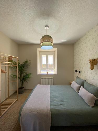a bedroom with a large bed and a window at La Finca de Aurora in San Rafael