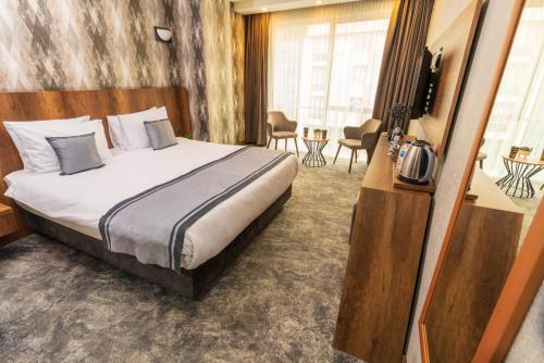 um quarto de hotel com uma cama e uma televisão em Istanbul Airport Express Hotel em Arnavutköy