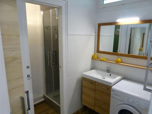 a bathroom with a shower and a sink and a mirror at La Cabane aux Ecureuils Appart à 500m de la plage Forêt in Mimizan
