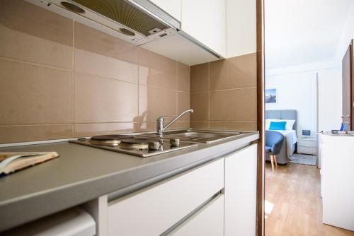 a kitchen with a sink and a stove at California Apartments in Dubrovnik