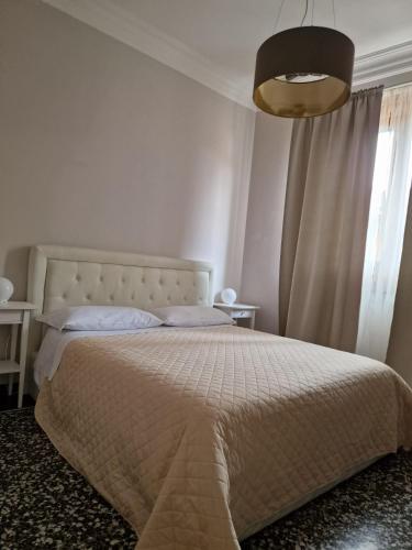 a bedroom with a large bed and a window at Le logge in Pisa