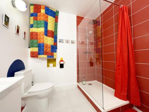a bathroom with a shower and a toilet and a sink at BricksRoom_Paris in Noisy-le-Sec