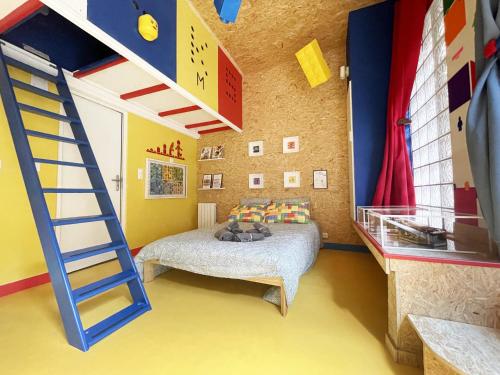 a bedroom with a bunk bed and a ladder at BricksRoom_Paris in Noisy-le-Sec
